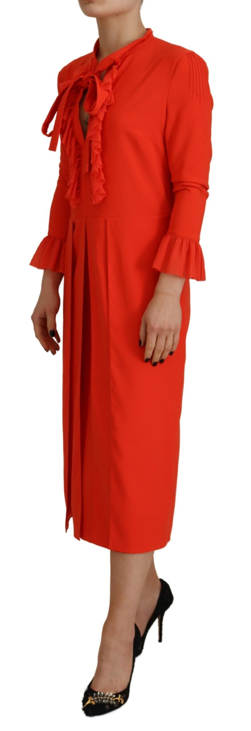 A red pleated midi dress with long sleeves and a high neckline