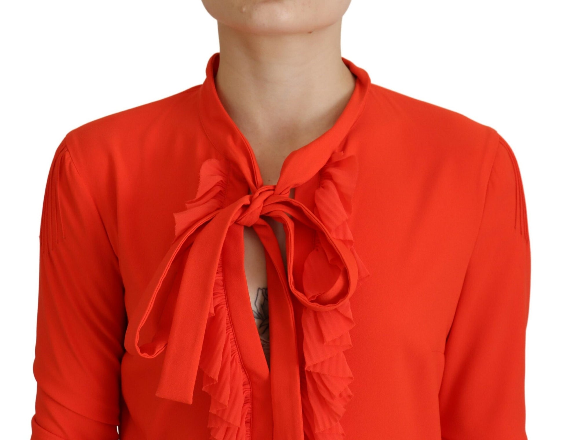 A red pleated midi dress with long sleeves and a bow neckline