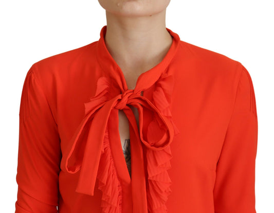 A red pleated midi dress with long sleeves and a bow neckline