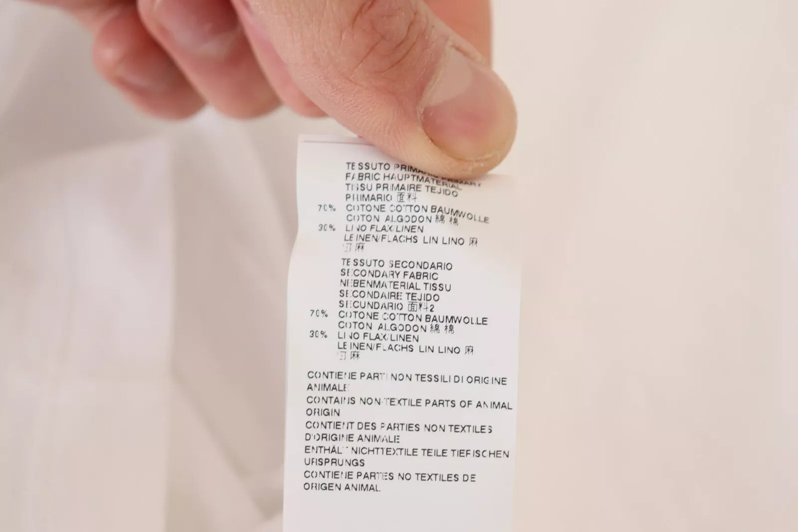 Hand holding a piece of paper with printed text
