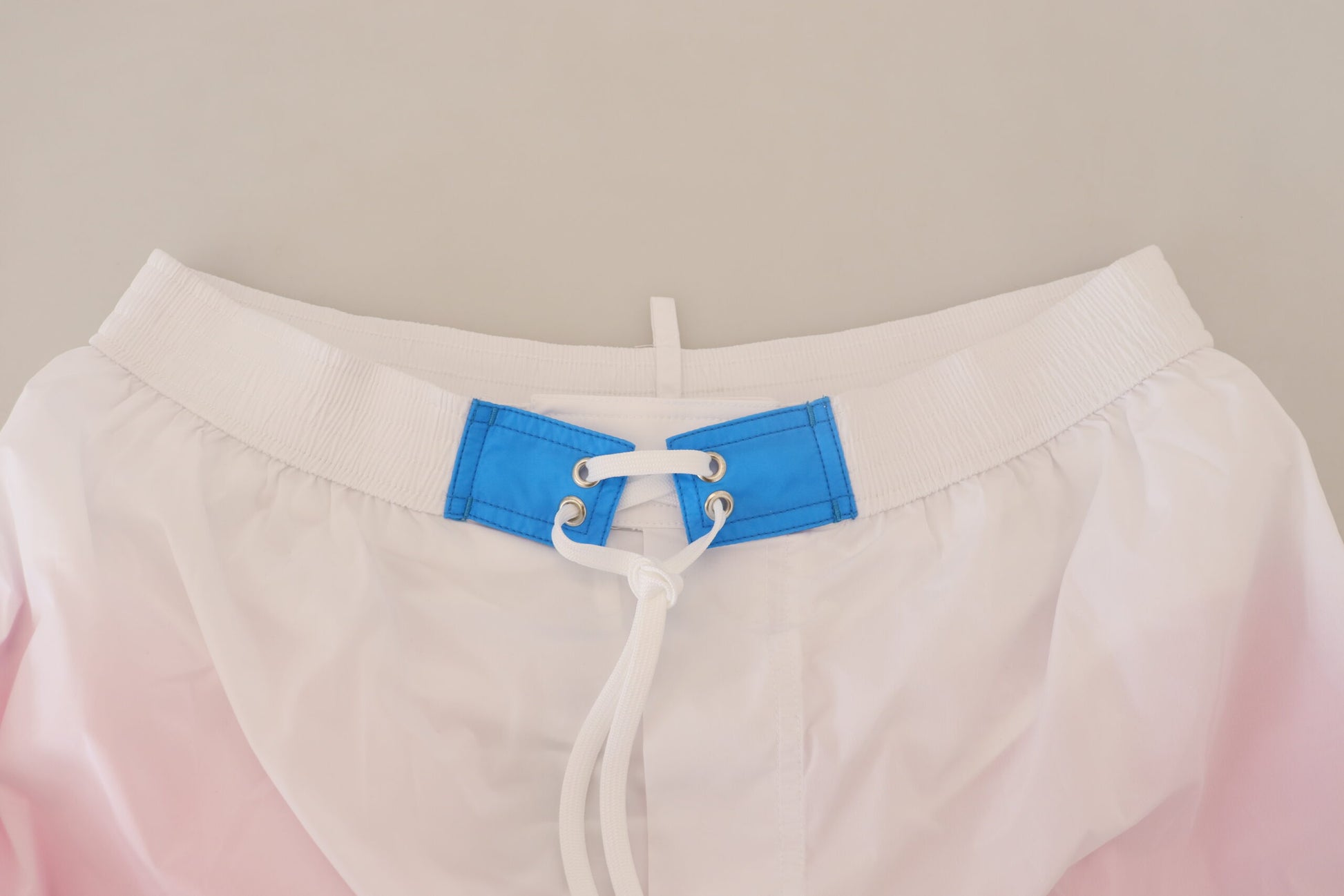 White shorts with blue straps and buckle
