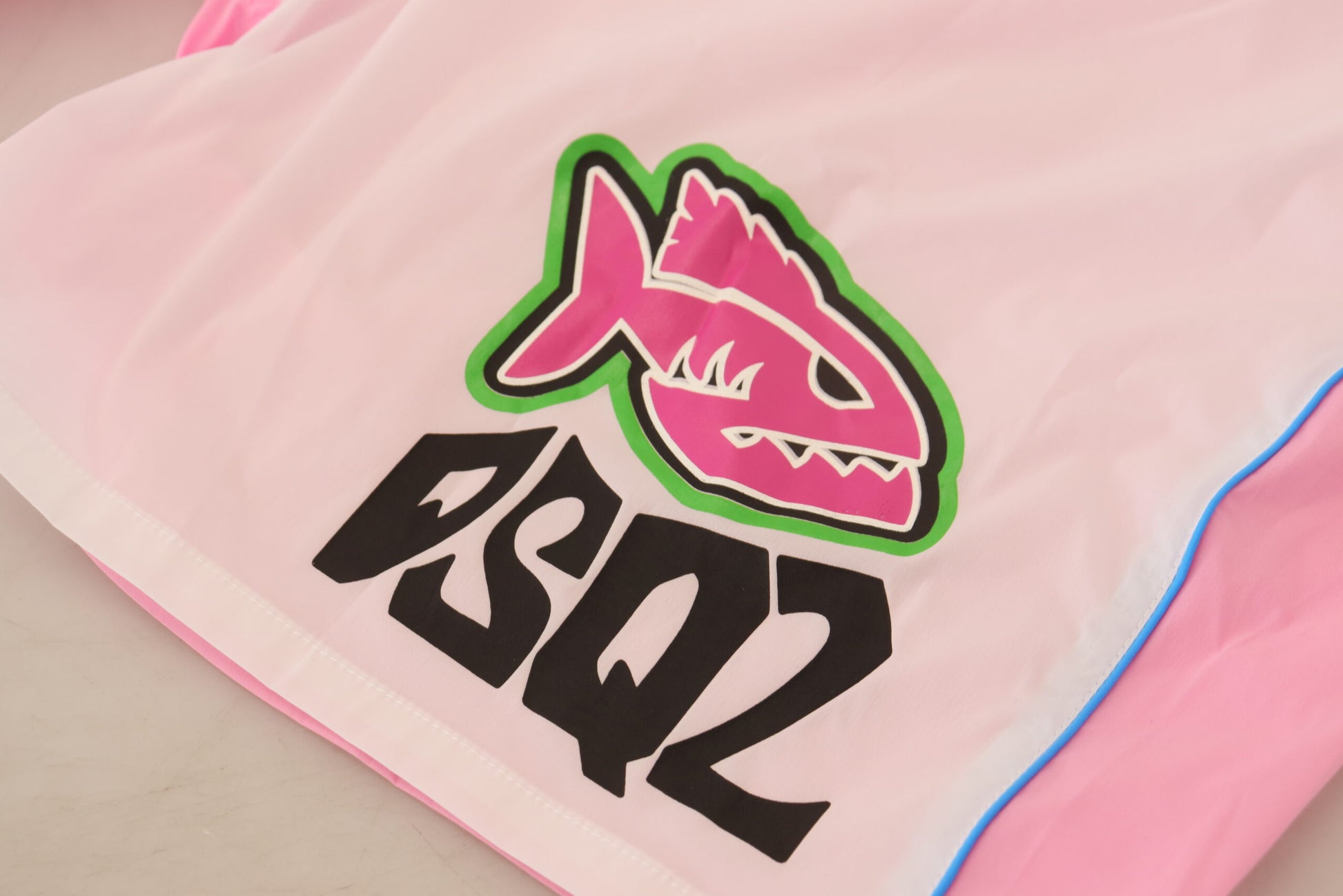 Pink towel with shark logo