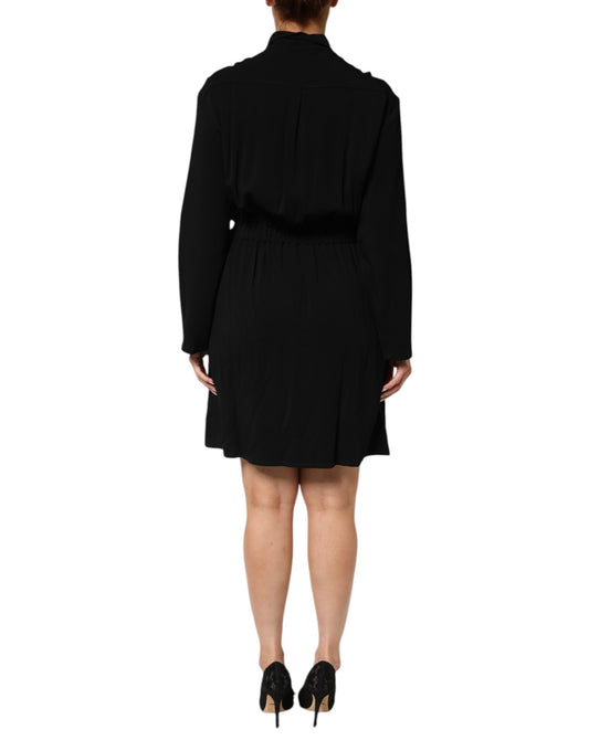 A black dress with short sleeves and a belted waist. It appears to be made of a viscose blend fabric, which i