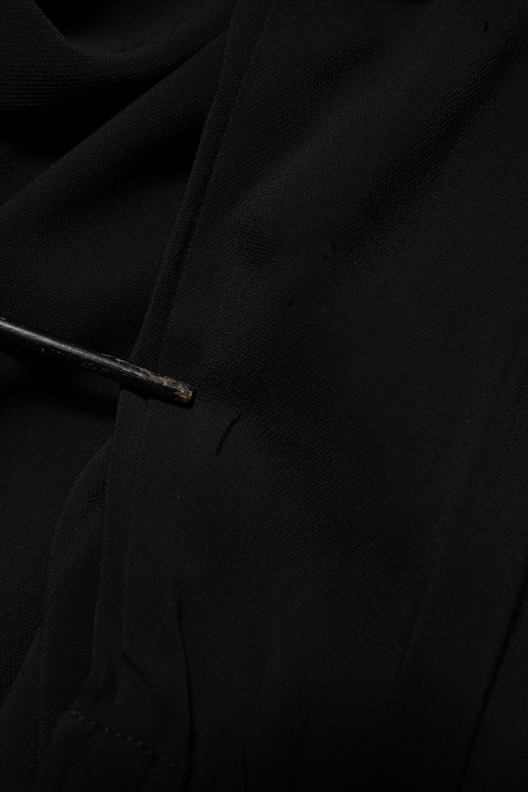 A black viscose blend shirt style belted dress with a visible button closure