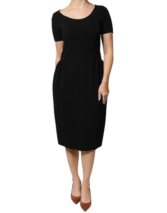A black midi dress with short sleeves and a sheath silhouette