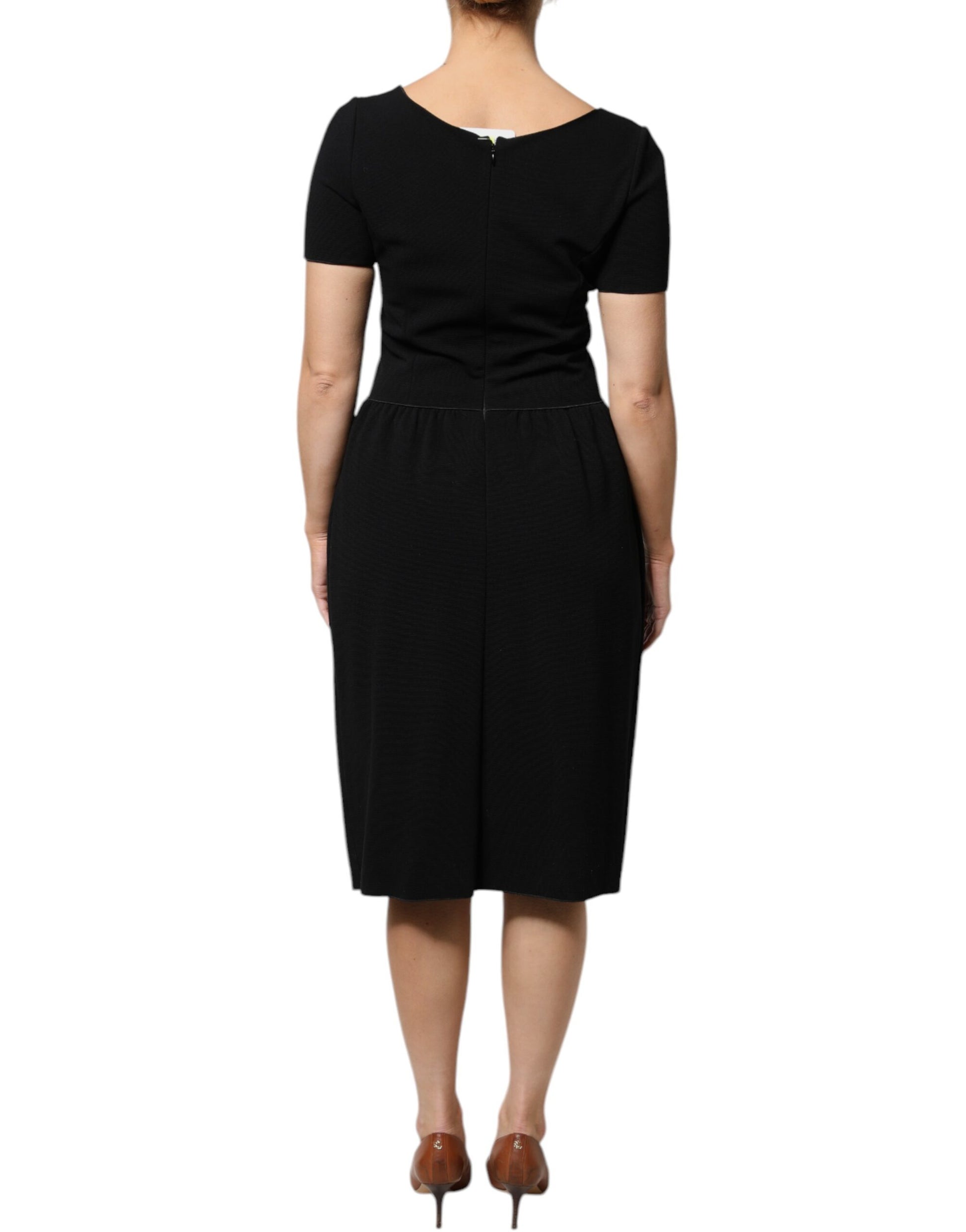 A black midi dress with short sleeves and a sheath silhouette