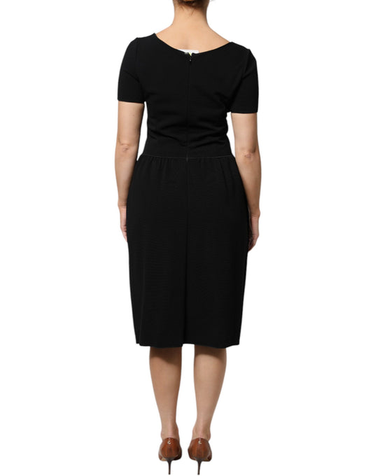 A black midi dress with short sleeves and a sheath silhouette