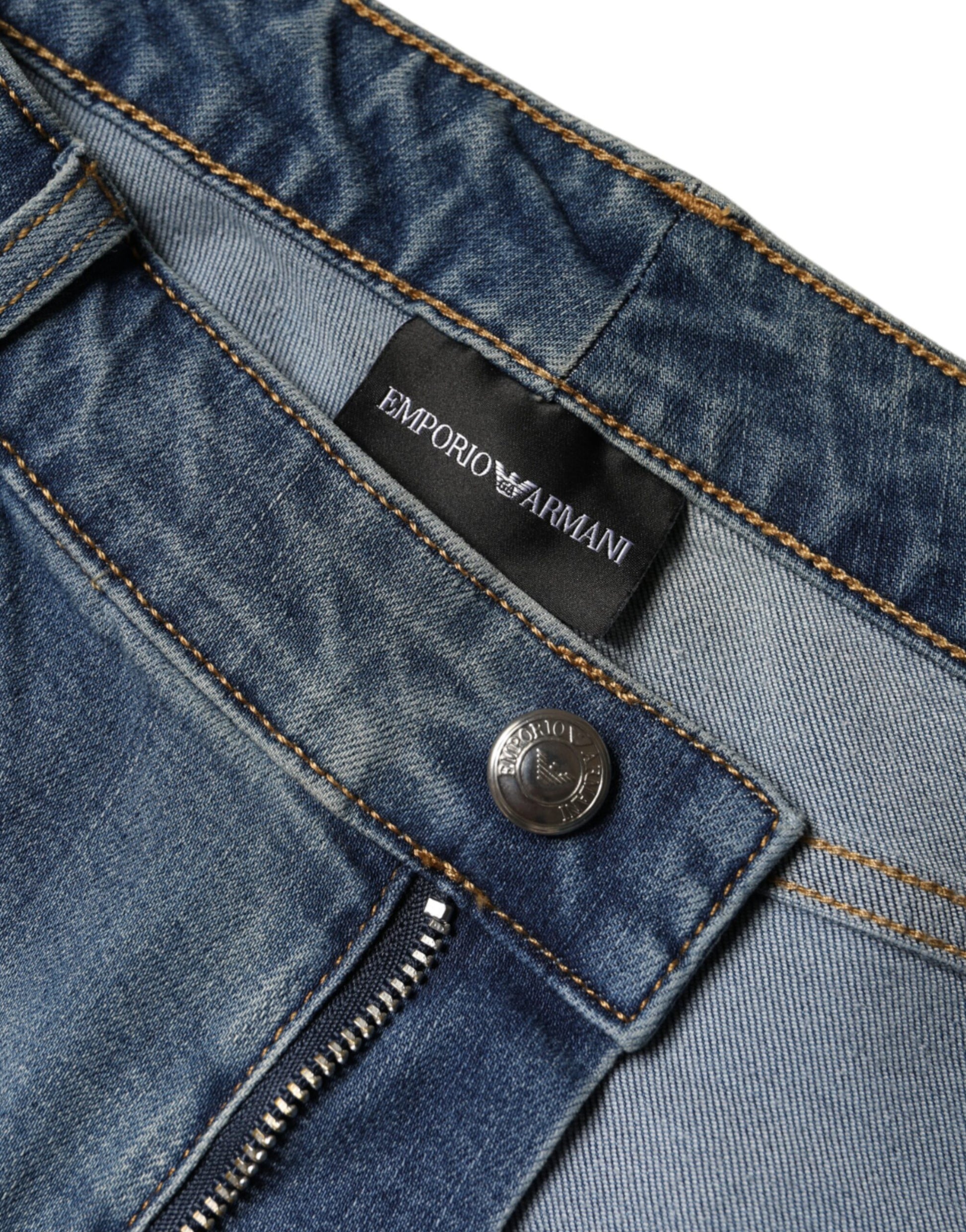 Blue denim jeans with zippered fly and button closure