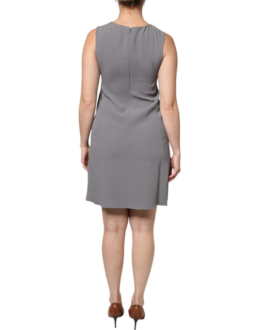 A gray sleeveless dress with a round neck and an A-line silhouette. It is a mini dress, suitable for casual w