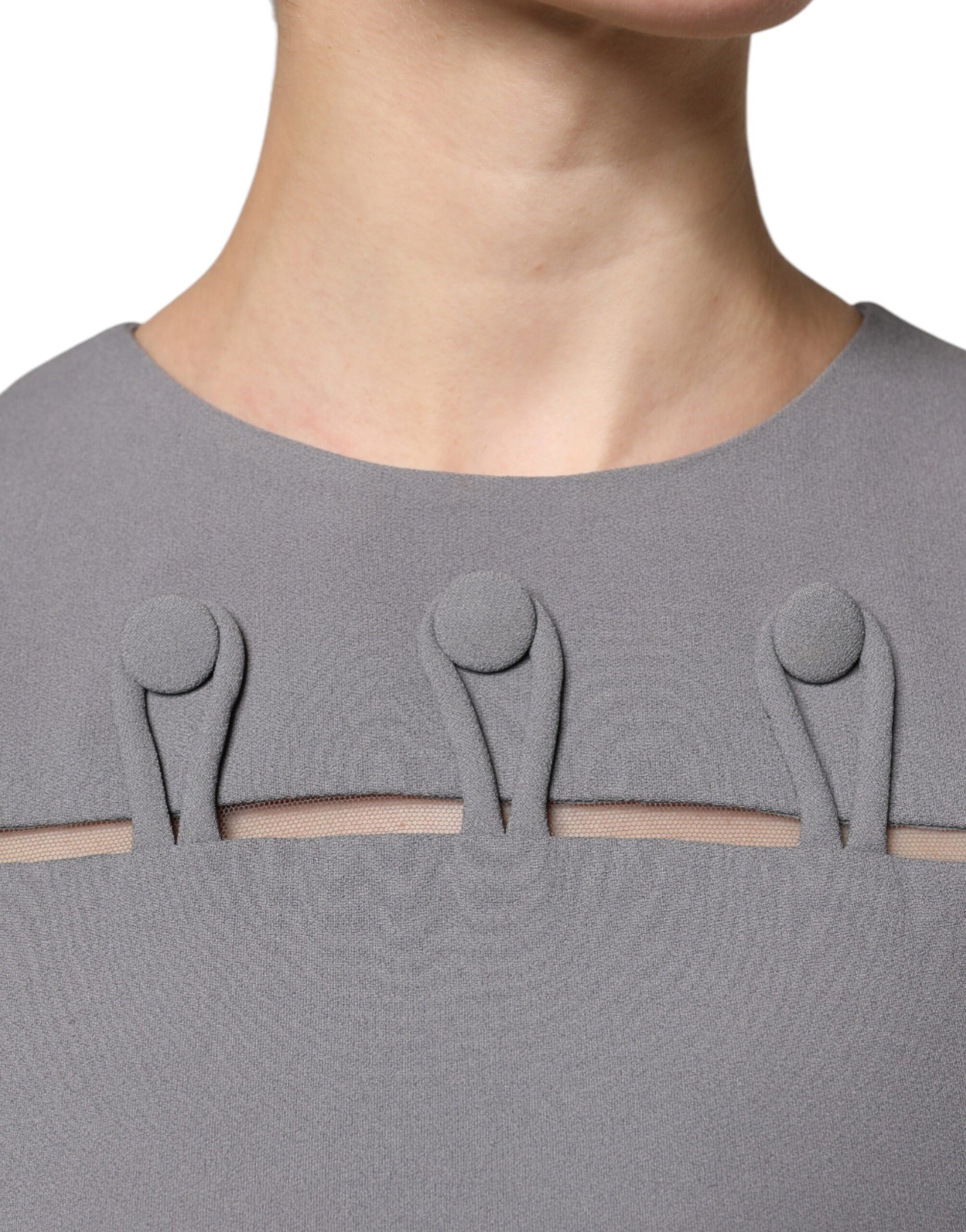 A gray sleeveless dress with a round neck and three buttons down the front. It is an A-line mini dress from E