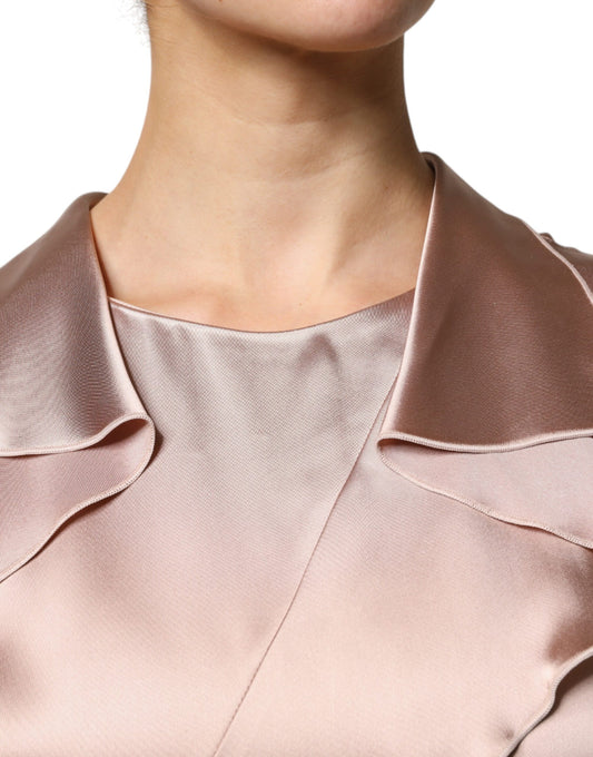 A pink satin long sleeve sheath wrap mini dress with a V-neckline