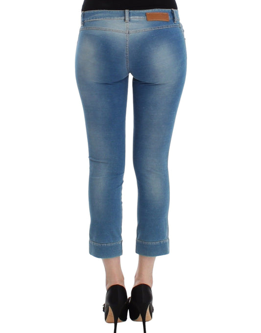 Pair of blue jeans with faded wash and rolled up cuffs