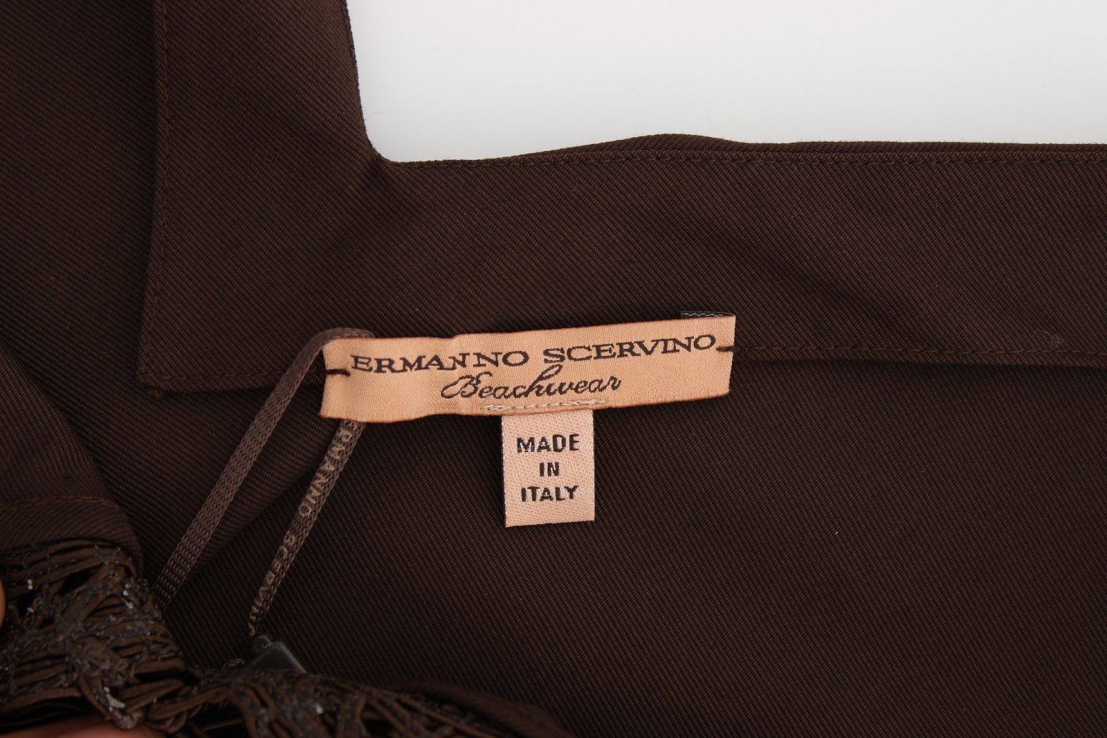 Brown fabric with label reading "Gianni Versace Made in Italy"