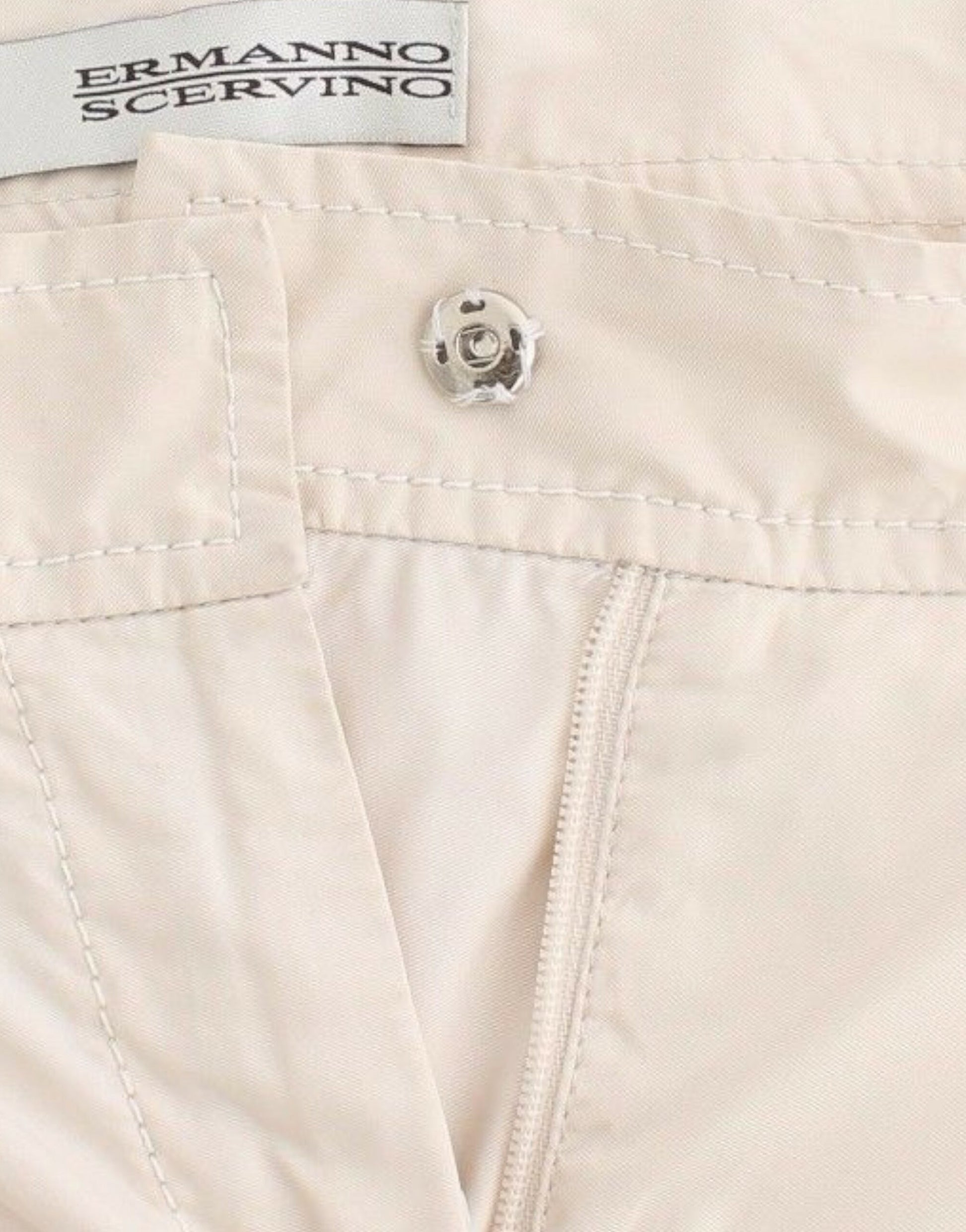 Pair of light beige pants with button closure