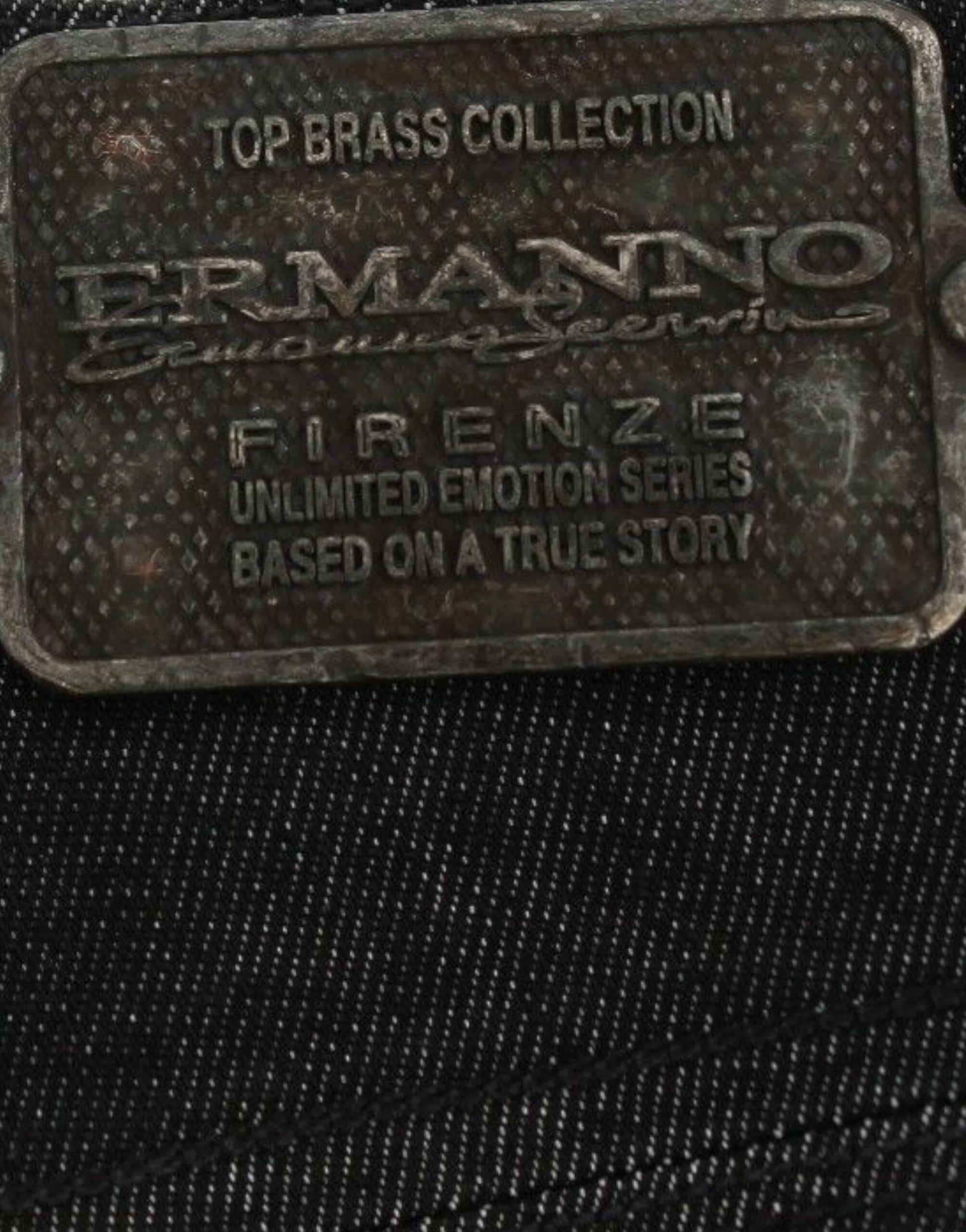 Metal tag with embossed logo and text