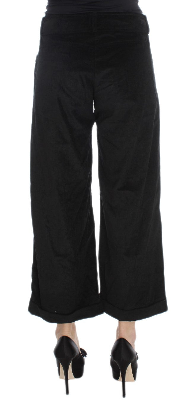 Black pants with flared legs and black heels