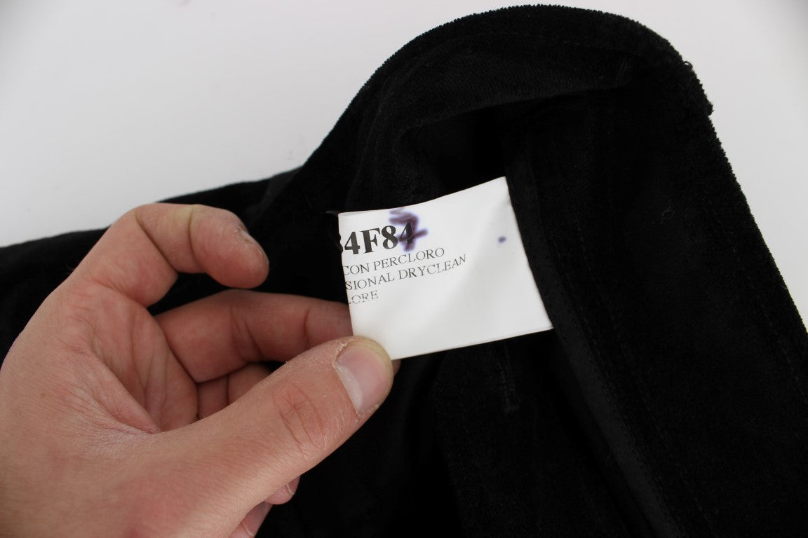 Hand holding tag on black fabric