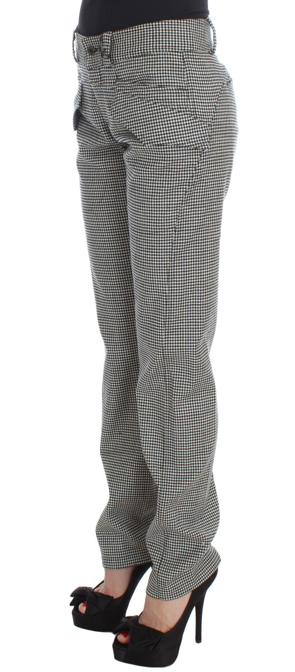 Pair of plaid pants worn by a person standing against a white background