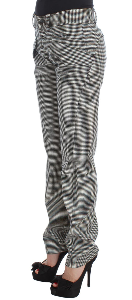 Pair of plaid pants worn by a person standing against a white background