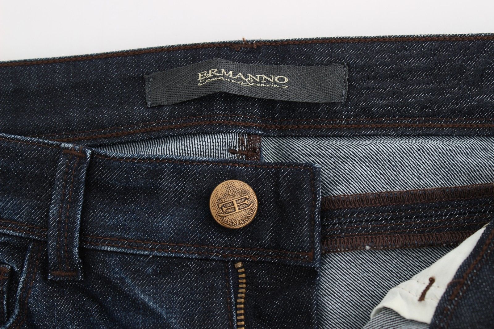 Blue denim jeans with button closure and coin tag on waistband