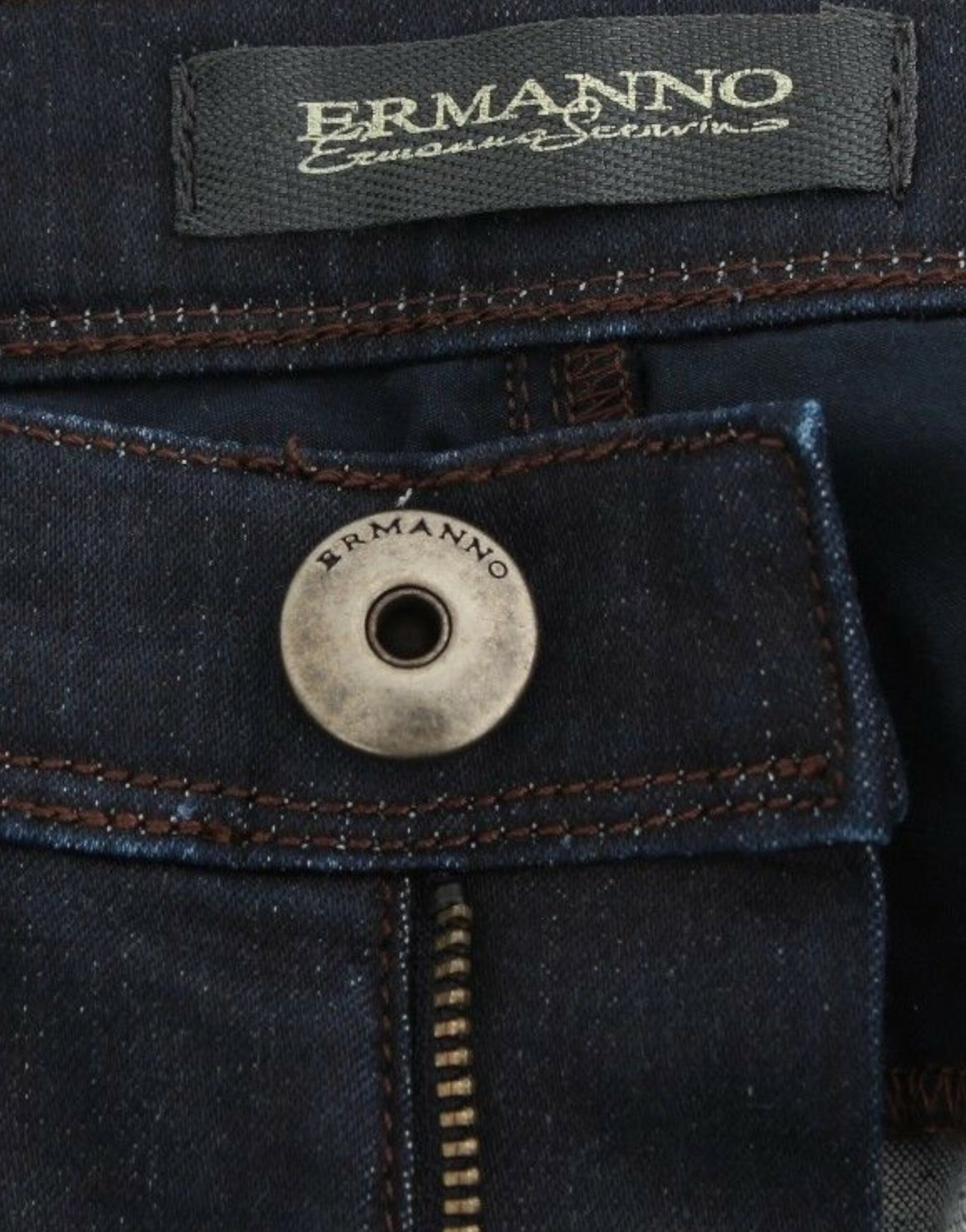 Blue jeans with brand label on waistband and button closure