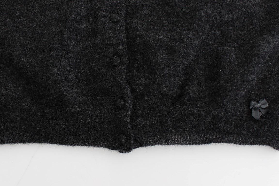 Dark wool coat with buttons and a bow on the front