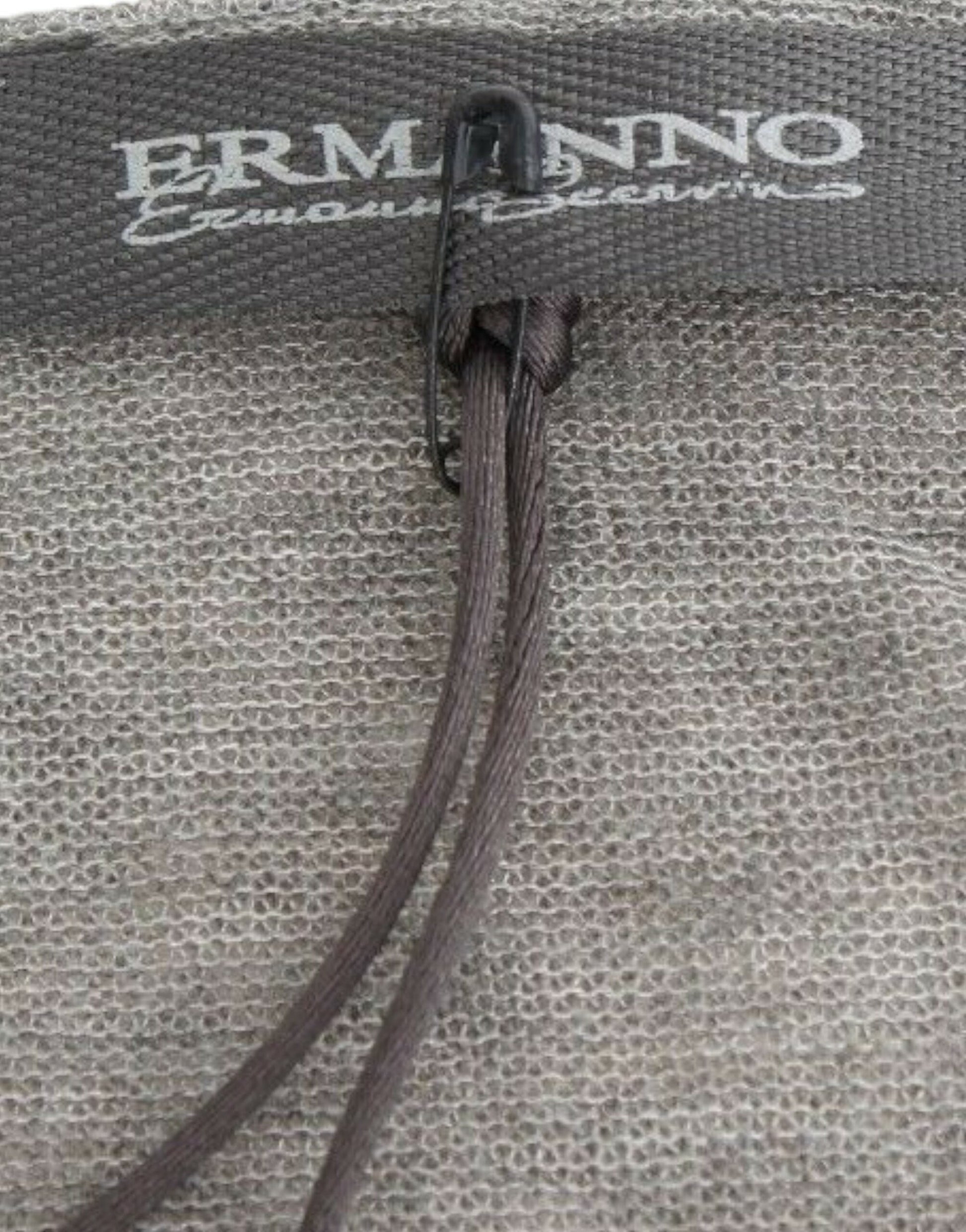 Brown leather strap on a gray fabric item