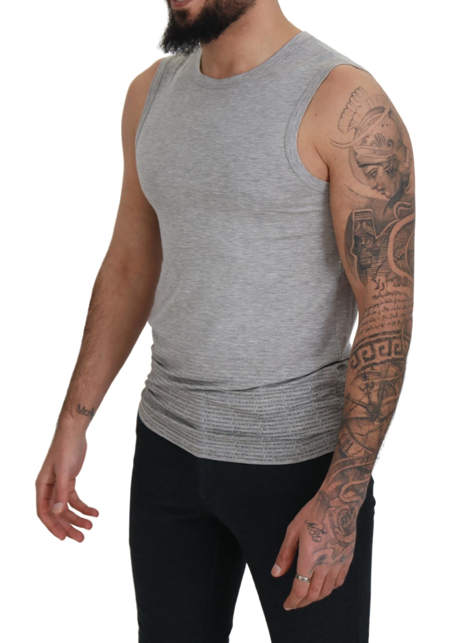 Man wearing sleeveless shirt and tattoos on arms