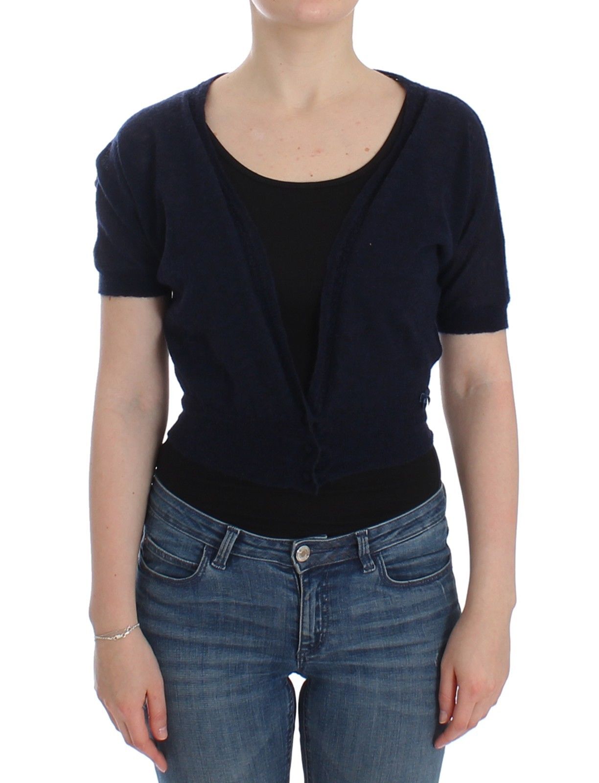 Woman wearing blue cardigan over black top and jeans