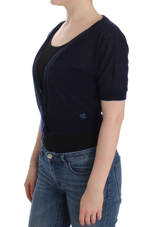 Woman wearing black cardigan over black top and blue jeans
