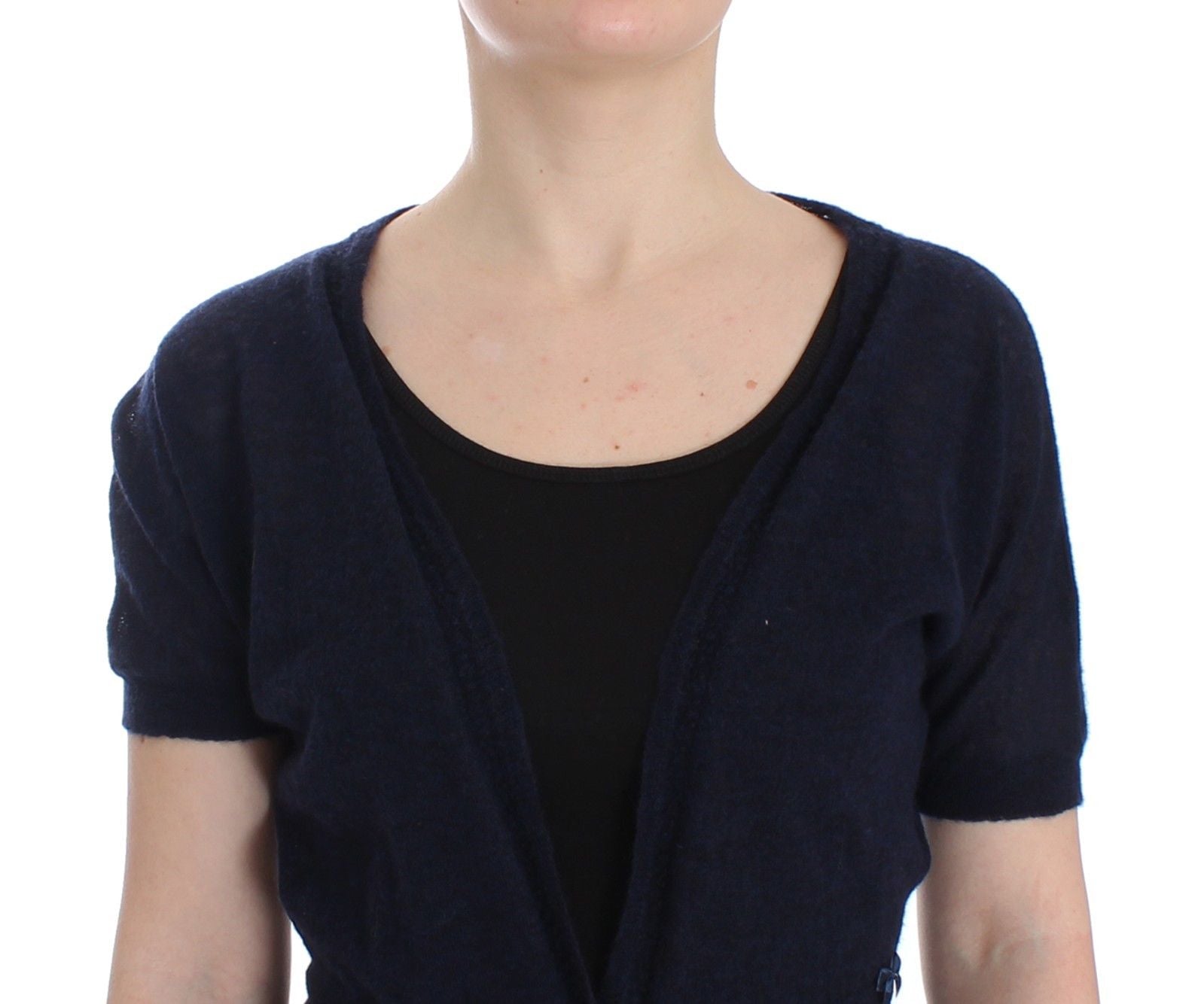 Woman wearing a dark blue cardigan over black top