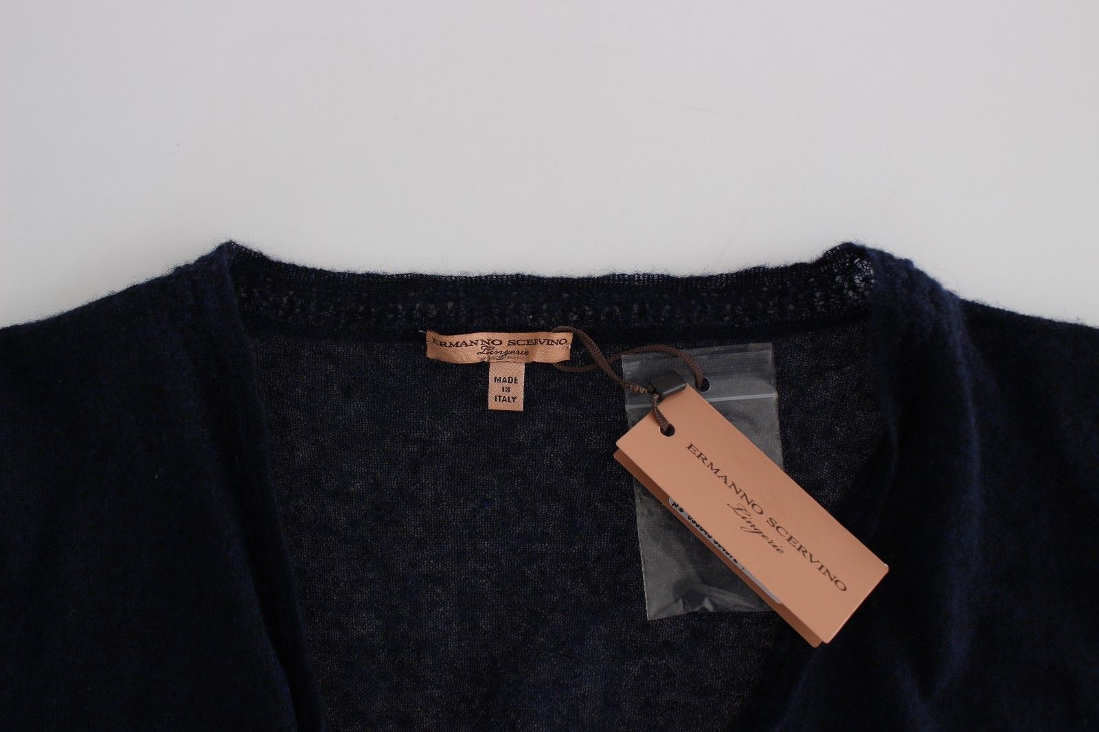 Black wool sweater on hanger with tag attached to neck