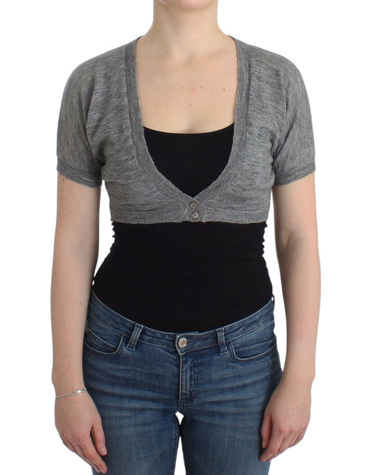 Woman wearing a gray cardigan over black tank top