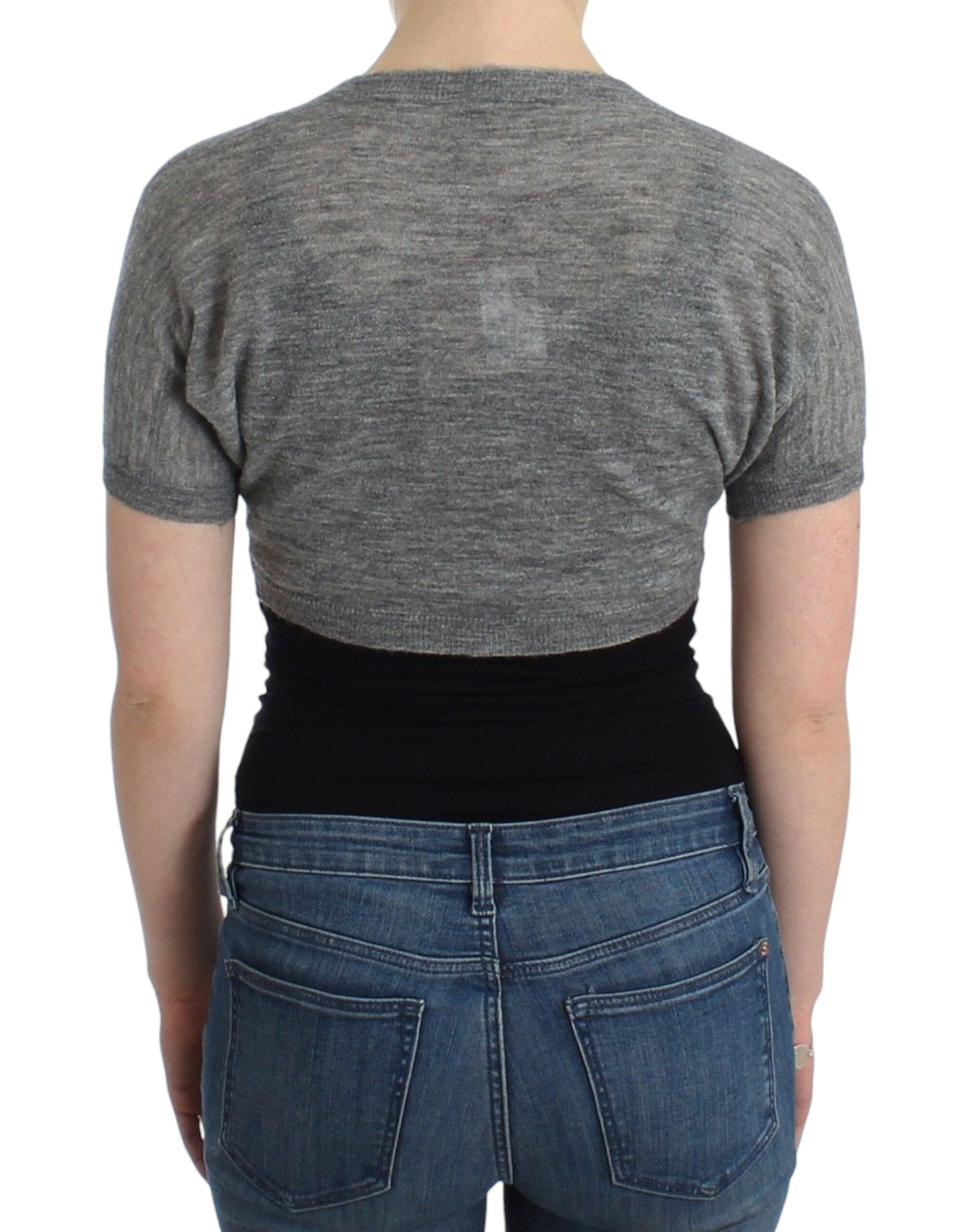 Woman wearing gray top and blue jeans