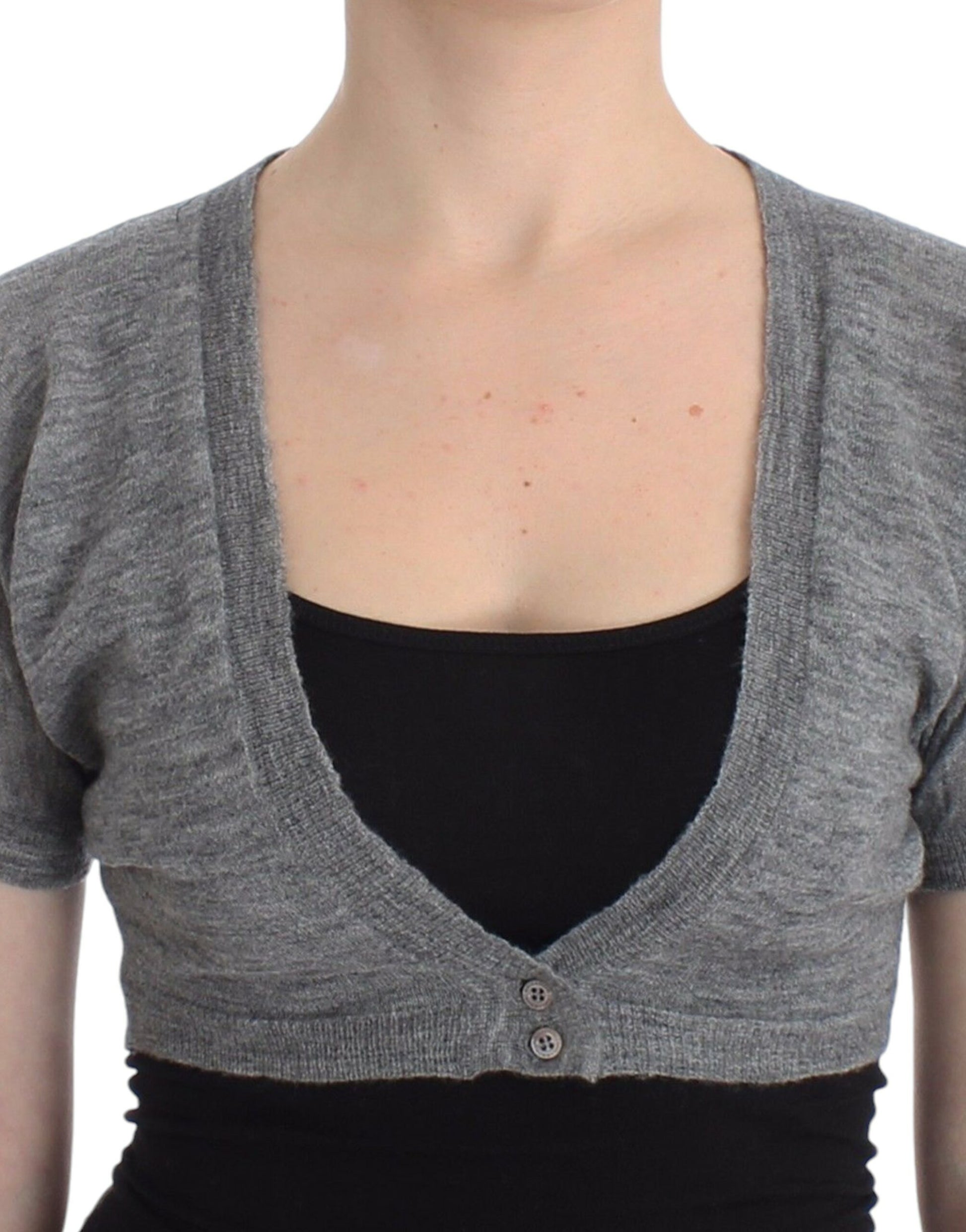 Woman wearing a gray cardigan over black top