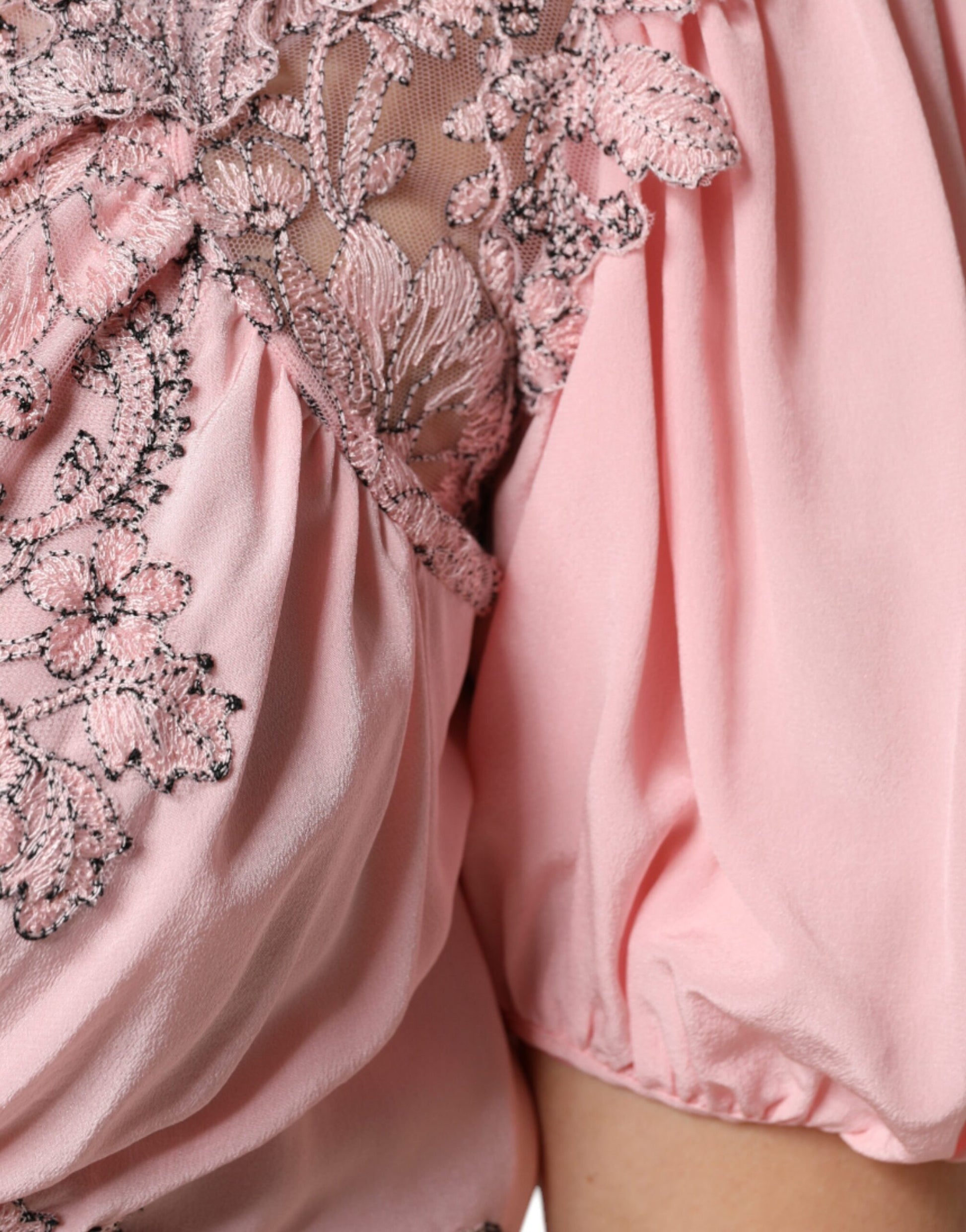 A pink floral lace midi dress with short sleeves and a V-neck