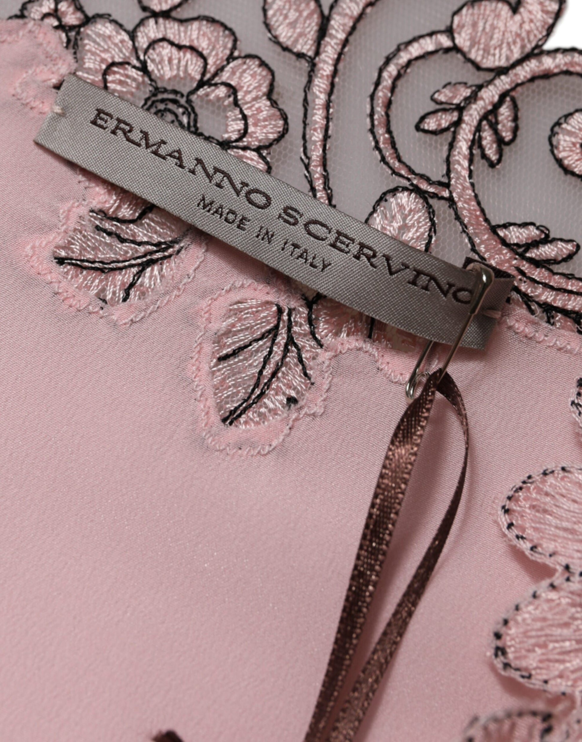 A pink floral lace midi dress with short sleeves and a V-neck