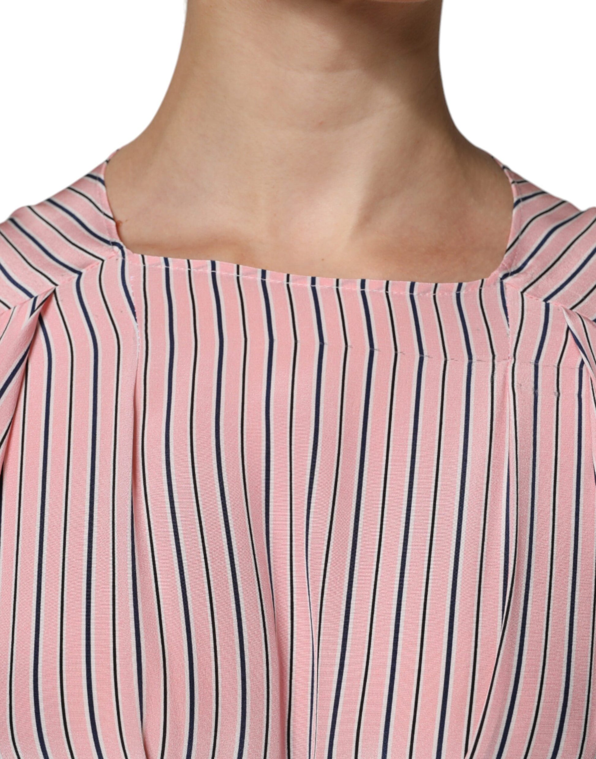 A pink and white striped midi dress with long sleeves