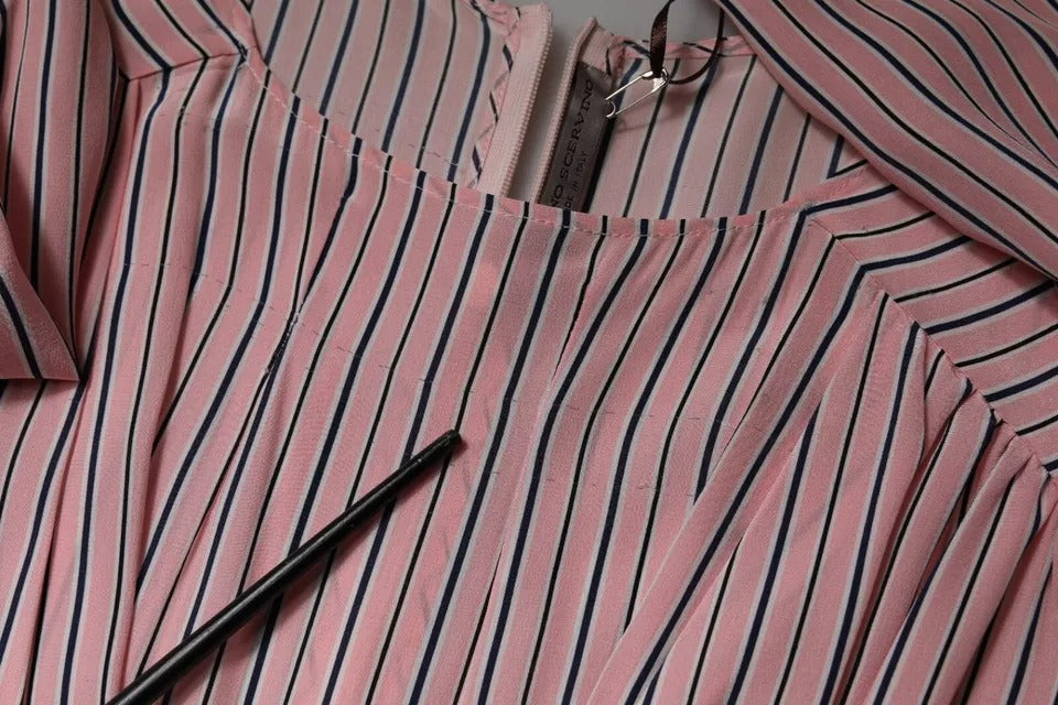 A pink striped silk midi dress with long sleeves