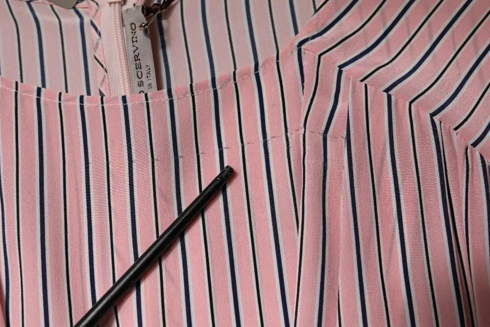A pink striped silk midi dress with long sleeves
