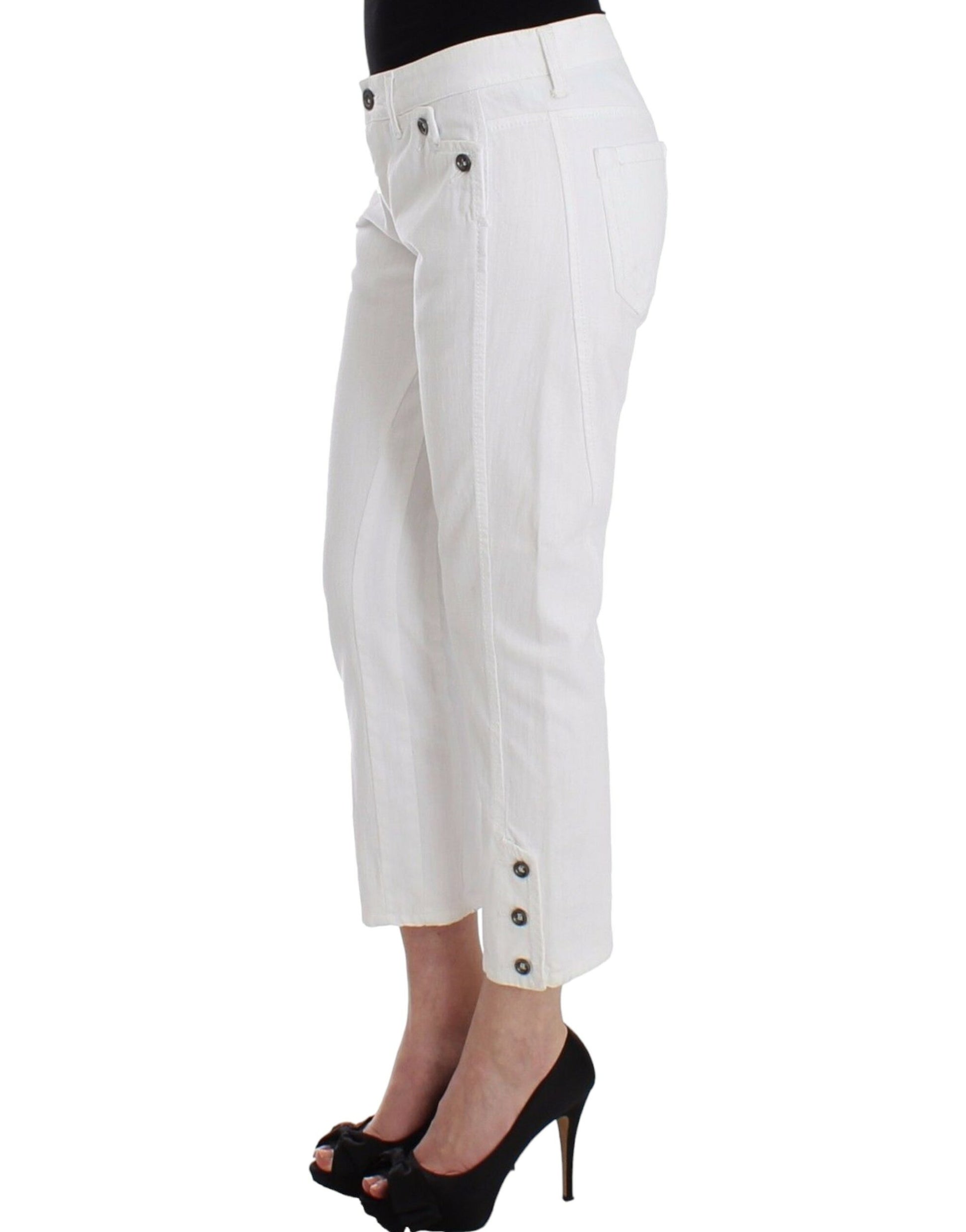 Woman wearing white pants and black heels