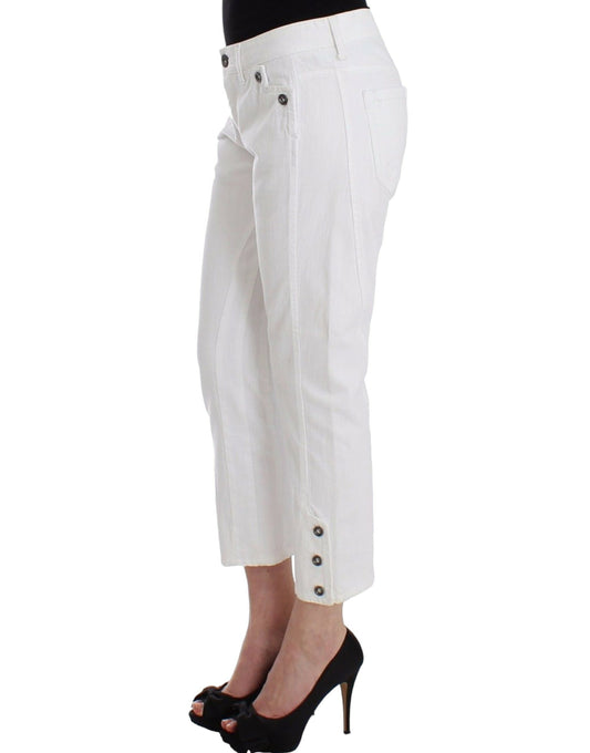 Woman wearing white pants and black heels