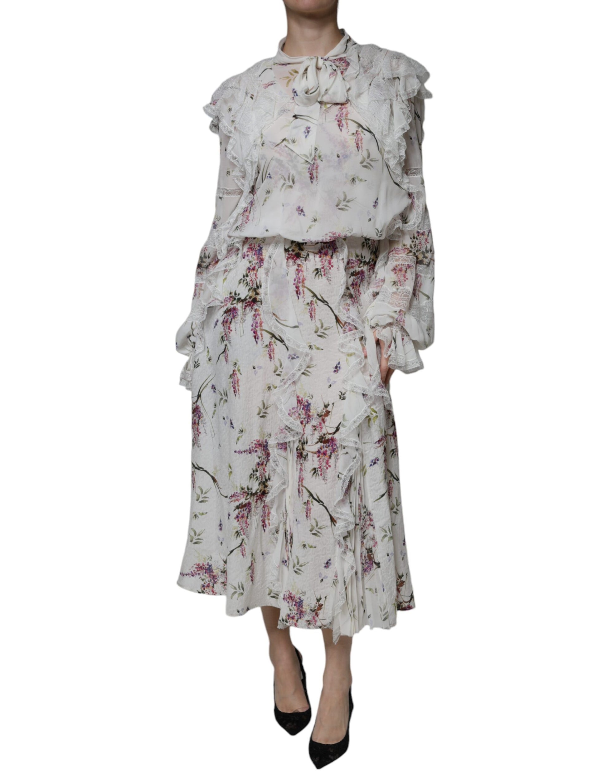 A long white dress with floral ruffles and lace detailing