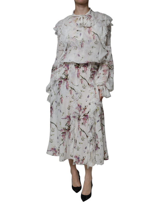 A long white dress with floral ruffles and lace detailing