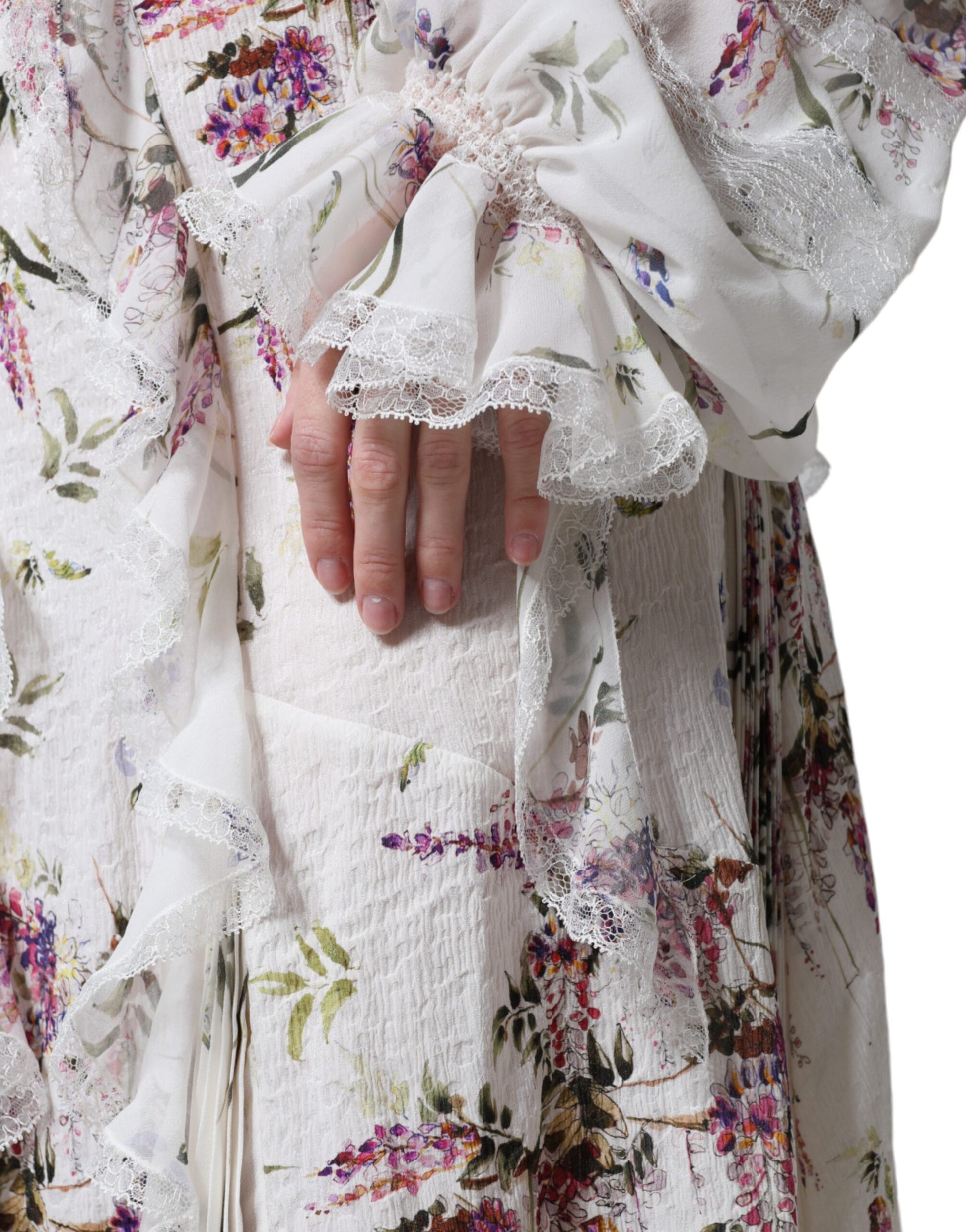 A white floral lace maxi dress with long sleeves and ruffled details