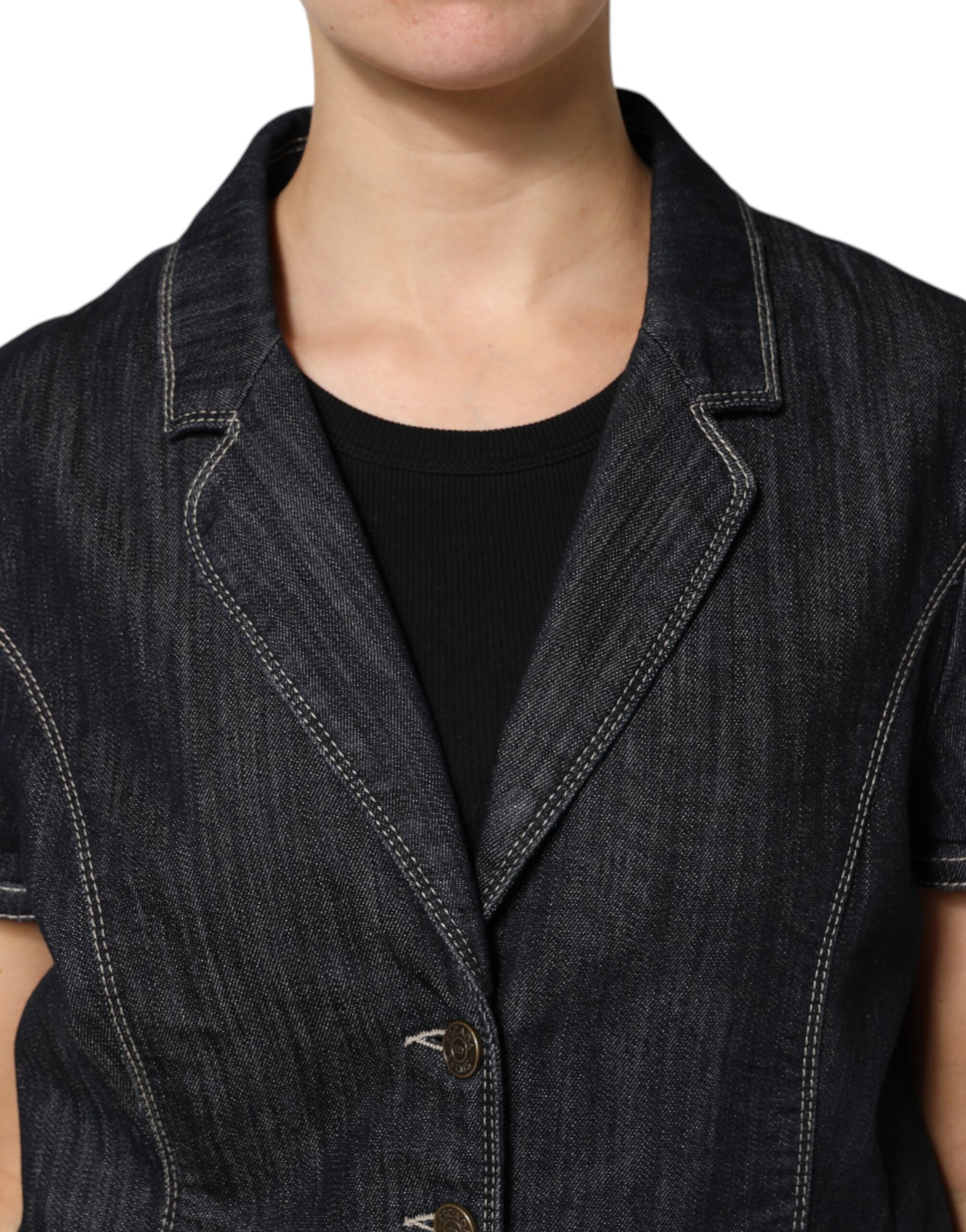 Woman wearing denim vest over black shirt