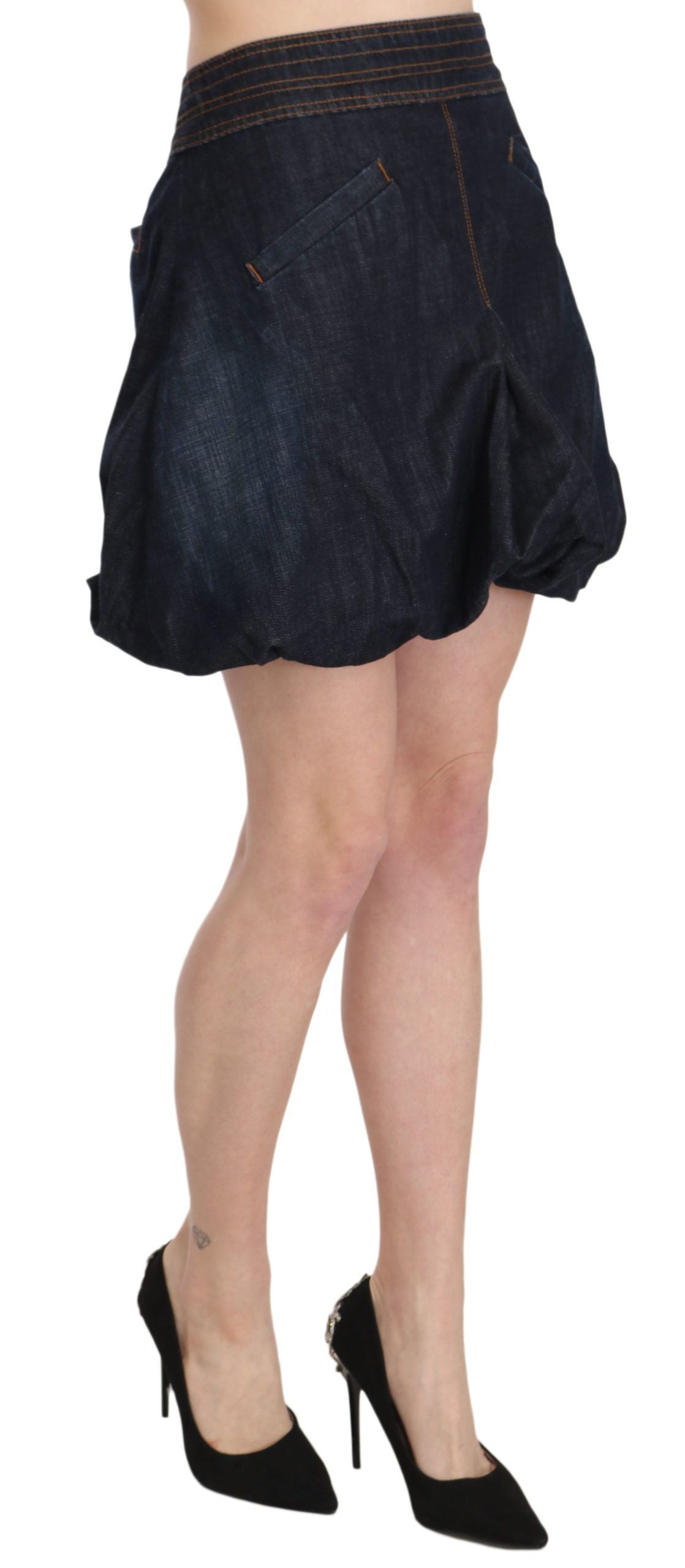 Woman wearing denim skirt and black heels