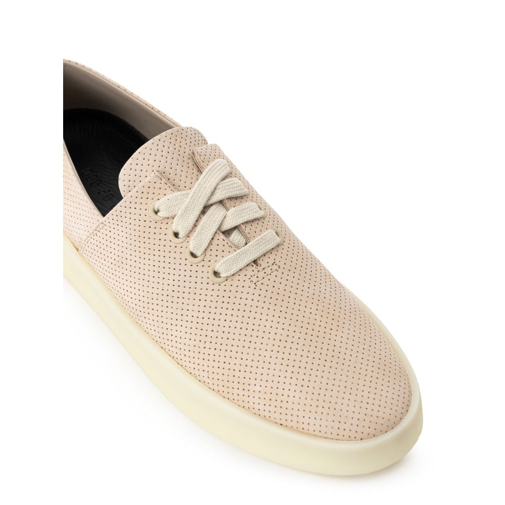 Tan canvas sneaker with white laces and sole
