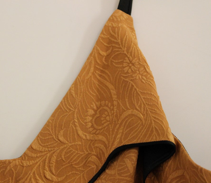 Yellow apron hanging on wall