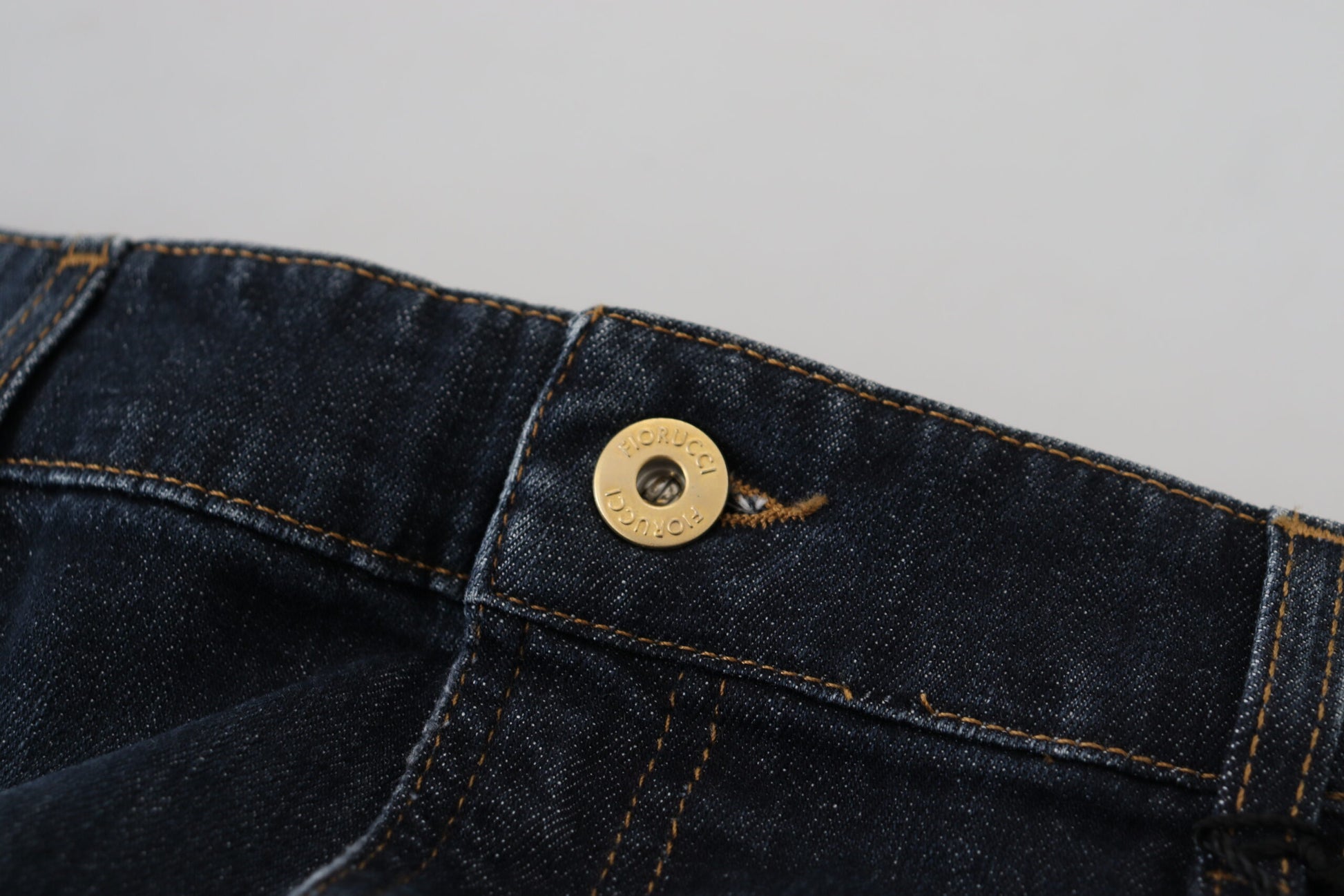 Blue denim jeans with gold button